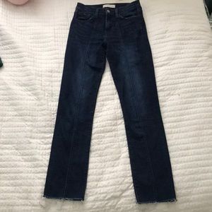 Dark wash denim jeans with a center seam